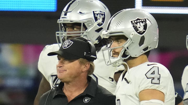 Jon Gruden talks with quarterback Derek Carr Jon Gruden talks with quarterback Derek Carr