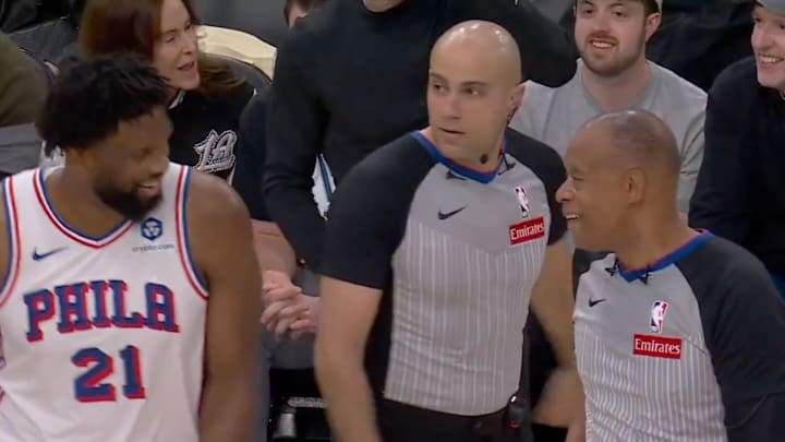 Joel Embiid has a laugh with officials during a replay review.