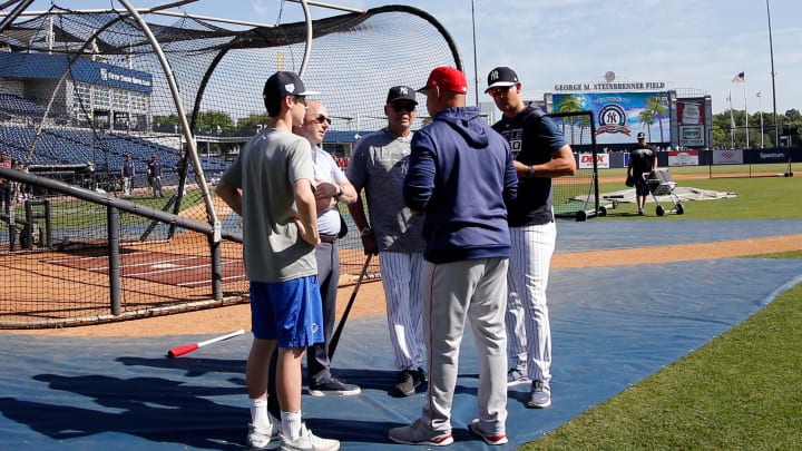 Mar 15, 2019; Tampa, FL, USA; New York Yankees general manger Brian Cashman, hall of fame Reggie Jackson, manager Aaron Boone (17) andBoston Red Sox manager Alex Cora (20) talk prior to the game at George M. Steinbrenner Field. Mandatory Credit: Kim Klement-USA TODAY Sports