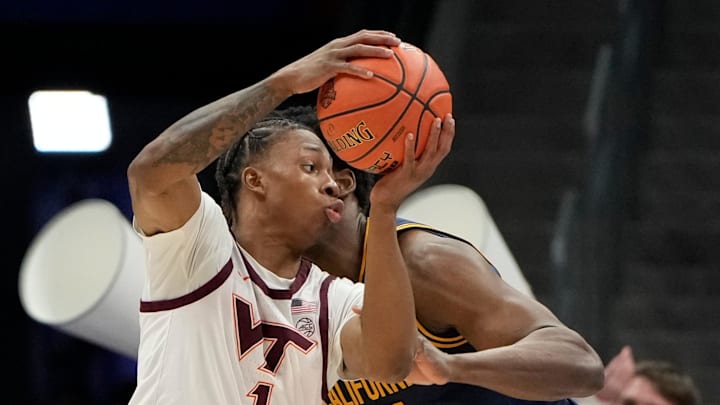 Mar 11, 2025; Charlotte, NC; Virginia Tech forward Tobi Lawal (1) with the ball as California Golden Bears forward Lee Dort (34) defends.