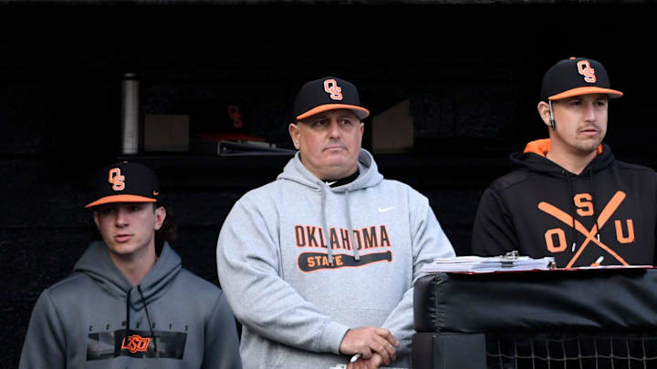 Oklahoma State's head baseball coach Josh Holliday, center, stands in the dugout during game one against Texas Tech, Friday, March 17, 2023, at Rip Griffin Park.
