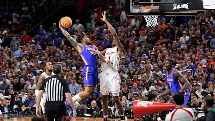 Florida's Alijah Martin (15) flies to the basket while Houston's Joseph Tugler tries to block.