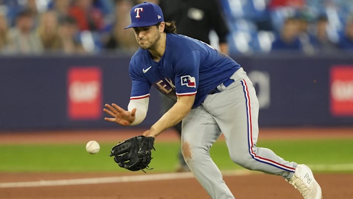 Sep 11, 2023; Toronto, Ontario, CAN; Texas Rangers baseman Josh H. Smith (47) fields a ground ball hit by Toronto Blue Jays first baseman Vladimir Guerrero Jr. (not pictured) during the eighth inning at Rogers Centre. Mandatory Credit: John E. Sokolowski-Imagn Images