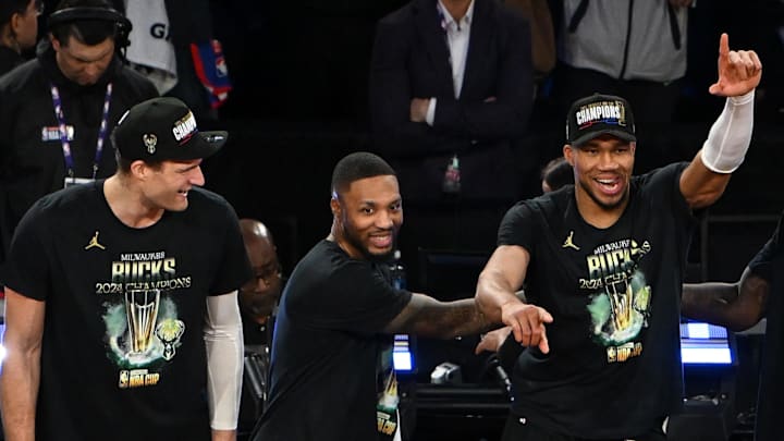 Dec 17, 2024; Las Vegas, Nevada, USA; (Left to right) Milwaukee Bucks center Brook Lopez (11), guard Damian Lillard (0) and forward Giannis Antetokounmpo (34) celebrate after winning the Emirates NBA Cup championship game against the Oklahoma City Thunder at T-Mobile Arena. Mandatory Credit: Candice Ward-Imagn Images