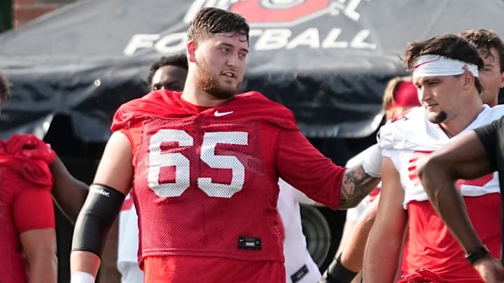 Aug 1, 2024; Columbus, OH, USA; Ohio State Buckeyes offensive lineman Zen Michalski (65) warms up during football camp at the Woody Hayes Athletic Complex.