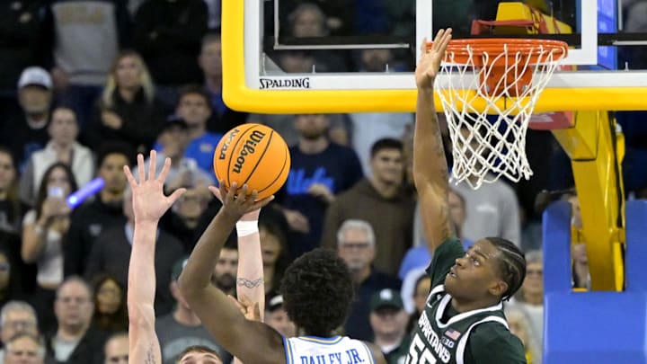 UCLA Bruins guard Eric Dailey Jr. shoots the winning basket over Michigan State Spartans center Carson Cooper and forward Coen Carr.