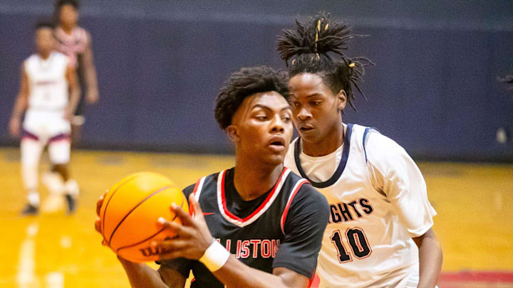 Williston High School guard Deandre Harvey (5) gets pressure from Vanguard's Jandrian Smith (10) as Vanguard takes on Williston during the Kingdom of the Sun basketball tournament at Vanguard High School in Ocala on Thursday, Dec. 28, 2023. Williston won 42-30.