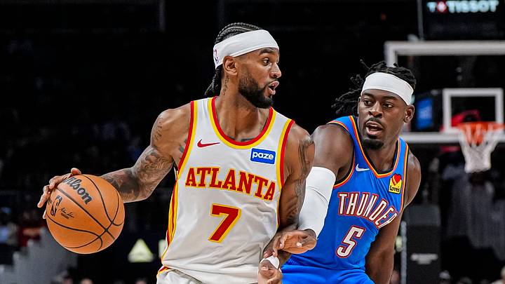 Oct 25, 2025; Atlanta, Georgia, USA; Atlanta Hawks guard Nickeil Alexander-Walker (7) is defended by Oklahoma City Thunder guard Luguentz Dort (5) during the first half at State Farm Arena. Mandatory Credit: Dale Zanine-Imagn Images