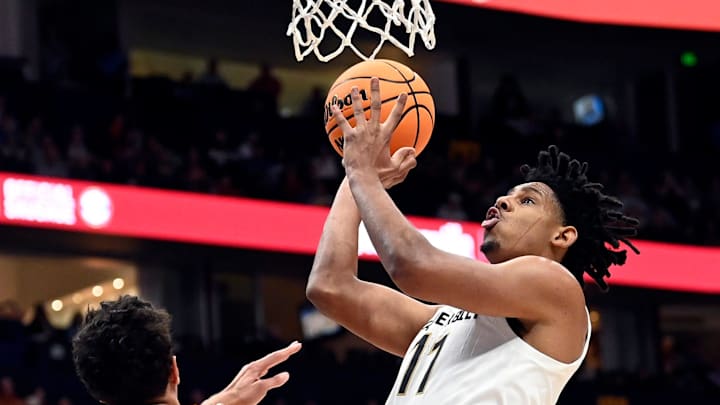 Vanderbilt guard A.J. Hoggard (11) shoots over Texas forward Kadin Shedrick (5) during a NCAA college basketball first round game at the men’s Southeastern Conference Tournament Wednesday, March 12, 2025, in Nashville, Tenn.
