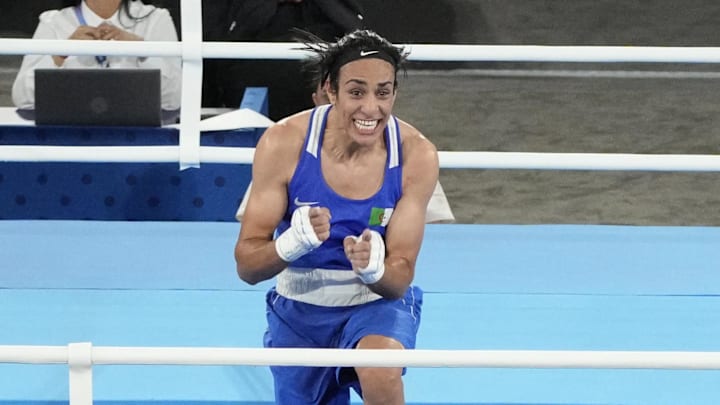 Aug 6, 2024; Paris, France; Imane Khelif (ALG) celebrates defeating Janjaem Suwannapheng (THA) in a women's 66kg semifinal bout during the Paris 2024 Olympic Summer Games at Stade Roland Garros. / Michael Madrid-USA TODAY Sports