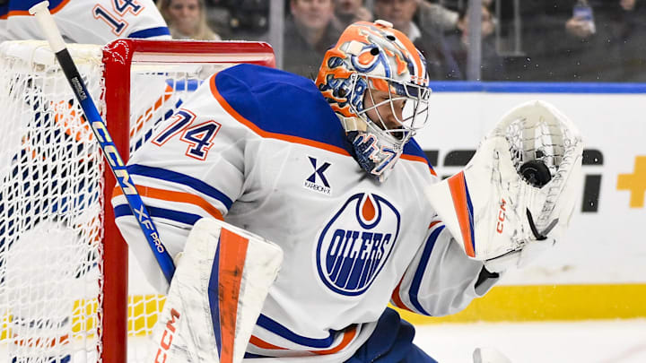 Feb 4, 2025; St. Louis, Missouri, USA; Edmonton Oilers goaltender Stuart Skinner (74) makes a glove save against the St. Louis Blues during overtime at Enterprise Center. Mandatory Credit: Jeff Curry-Imagn Images / Jeff Curry-Imagn Images