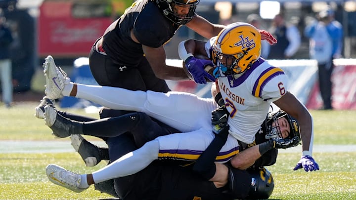 Dec 6, 2024; Birmingham, AL, USA; A trio of Cherokee County defenders bring down Jackson's Keeyun Chapman (6) at Protective Stadium in the AHSAA 4A State Championship game. / Gary Cosby Jr.
