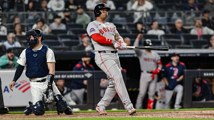 Boston Red Sox designated hitter Rafael Devers (11) reacts after hitting a solo home run 