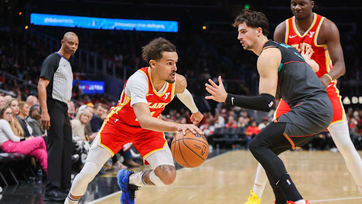 Jan 13, 2024; Atlanta, Georgia, USA; Atlanta Hawks guard Trae Young (11) drives on Washington Wizards forward Deni Avdija (8) in the second quarter at State Farm Arena. Mandatory Credit: Brett Davis-Imagn Images