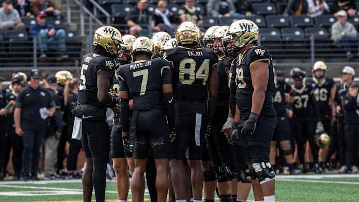 The Wake Forest offense huddles up before getting into their offensive positions. The Wake Forest offense huddles up before getting into their offensive positions.