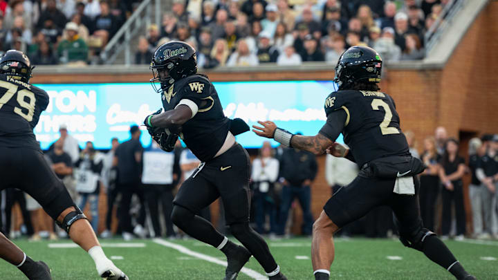 Wake Forest running back Demond Claiborne gets the handoff from quarterback Robby Ashford against North Carolina.