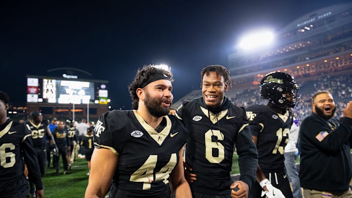 Wake Forest football players walk off the field after the game against North Carolina