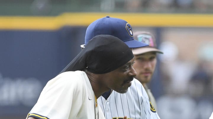 Snoop Dog walks off the field after throwing out the first pitch at the Cincinnati Reds and Milwaukee Brewers at American Family Field on June 15.