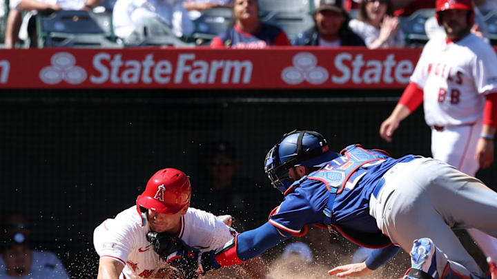 Sep 29, 2024; Anaheim, California, USA; Texas Rangers catcher Jonah Heim (28) tags out Los Angeles Angels catcher Matt Thaiss (21) at home plate during the seventh inning at Angel Stadium. Mandatory Credit: Kiyoshi Mio-Imagn Images Sep 29, 2024; Anaheim, California, USA; Texas Rangers catcher Jonah Heim (28) tags out Los Angeles Angels catcher Matt Thaiss (21) at home plate during the seventh inning at Angel Stadium. Mandatory Credit: Kiyoshi Mio-Imagn Images