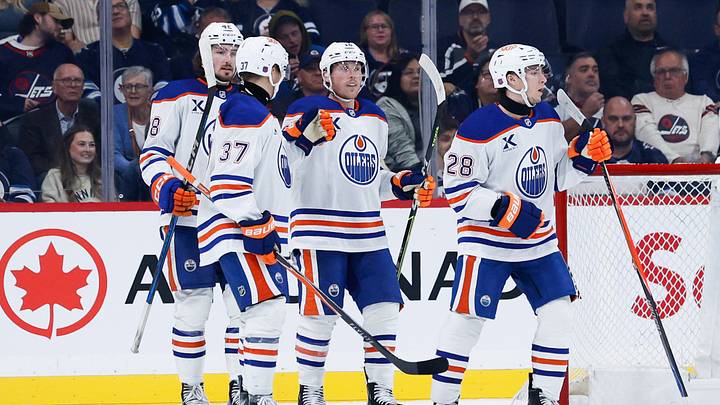 Sep 23, 2025; Winnipeg, Manitoba, CAN;  Edmonton Oilers forward Quinn Hutson (28) is congratulated by his teammates after scoring against the Winnipeg Jets during the second period at Canada Life Centre. Mandatory Credit: Terrence Lee-Imagn Images