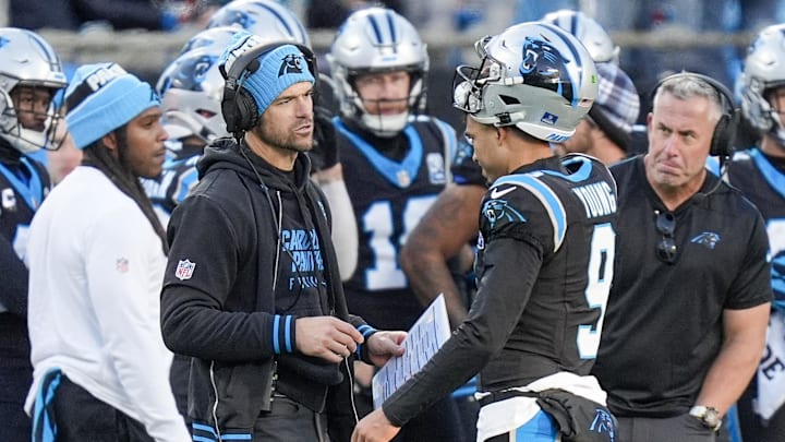Dec 22, 2024; Charlotte, North Carolina, USA; Carolina Panthers head coach Dave Canales talks with quarterback Bryce Young (9) during a time out during the second half against the Arizona Cardinals at Bank of America Stadium. Mandatory Credit: Jim Dedmon-Imagn Images