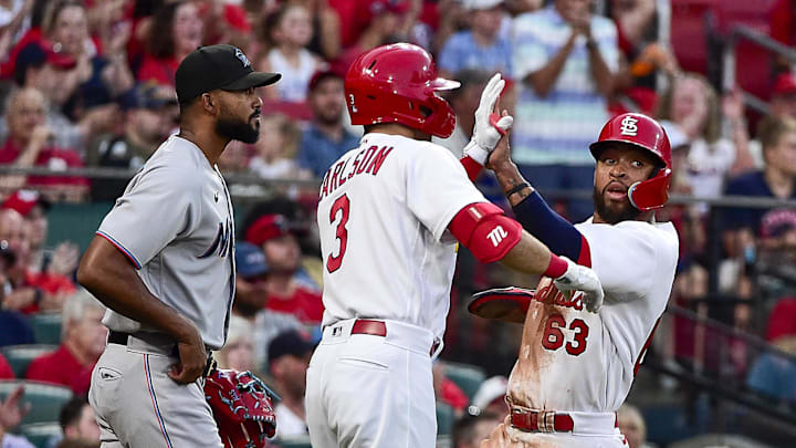 Jun 29, 2022; St. Louis, Missouri, USA;  St. Louis Cardinals shortstop Edmundo Sosa (63) celebrates with center fielder Dylan Carlson (3) as Miami Marlins starting pitcher Sandy Alcantara (22) looks on after scoring during the fifth inning at Busch Stadium. Mandatory Credit: Jeff Curry-Imagn Images