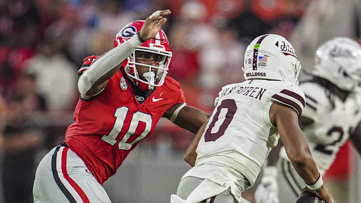 Oct 12, 2024; Athens, Georgia, USA; Georgia Bulldogs linebacker Damon Wilson II (10) tries to tackle Mississippi State Bulldogs quarterback Michael Van Buren Jr. (0) at Sanford Stadium. Mandatory Credit: Dale Zanine-Imagn Images
