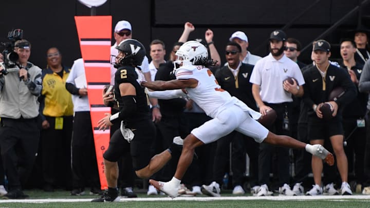 Oct 26, 2024; Nashville, Tennessee, USA;  Vanderbilt Commodores quarterback Diego Pavia (2) scores a touchdown against Texas Longhorns defensive back Jaylon Guilbeau (3) during the first half at FirstBank Stadium. Mandatory Credit: Steve Roberts-Imagn Images