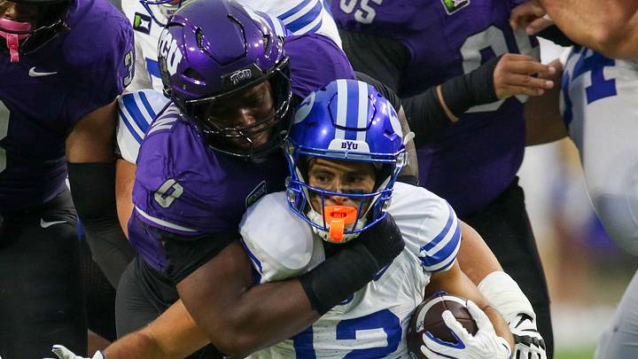 TCU defender Zach Chapman (0) wraps up BYU running back Preston Rex (12) at Amon G. Carter Stadium on Oct. 3, 2026. TCU defender Zach Chapman (0) wraps up BYU running back Preston Rex (12) at Amon G. Carter Stadium on Oct. 3, 2026.