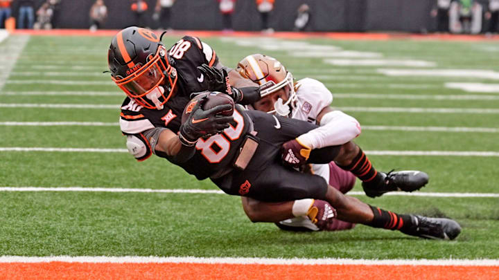 Oklahoma State Cowboys wide receiver Brennan Presley (80) scores a touchdown as Arizona State Sun Devils defensive back Keith Abney II (1) defends in the first half of the college football game between the Oklahoma State Cowboys and the Arizona State Sun Devils at Boone Pickens Stadium in Stillwater, Okla., Saturday, Nov., 2, 2024.
