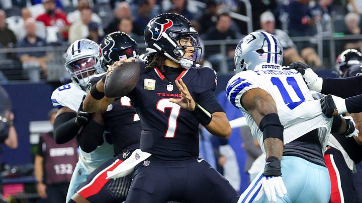 Nov 18, 2024; Arlington, Texas, USA; Houston Texans quarterback C.J. Stroud (7) throws as Dallas Cowboys linebacker Micah Parsons (11) rushes during the first half at AT&T Stadium. Mandatory Credit: Kevin Jairaj-Imagn Images
