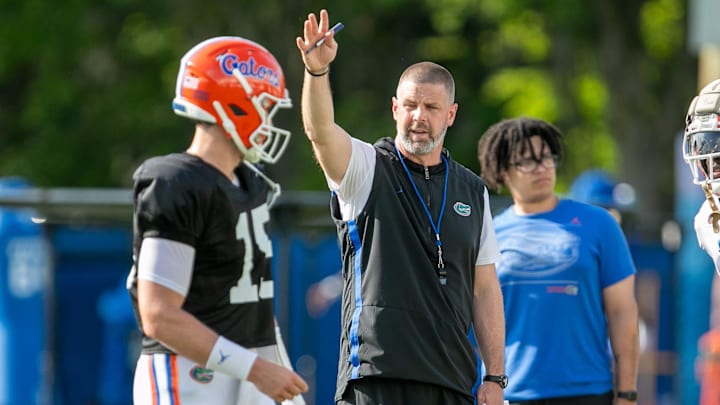 Florida head coach Billy Napier coaches Florida quarterback Graham Mertz (15) during Florida spring football practice at Sanders Practice Fields in Gainesville, FL on Tuesday, March 26, 2024. [Alan Youngblood/Gainesville Sun]