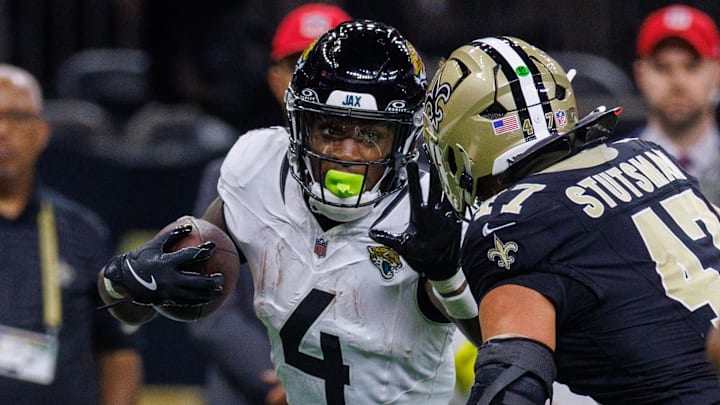 Aug 17, 2025; New Orleans, Louisiana, USA; Jacksonville Jaguars running back Tank Bigsby (4) pushes away the tackle of New Orleans Saints linebacker Danny Stutsman (47) during the first half at Caesars Superdome. Mandatory Credit: Stephen Lew-Imagn Images Aug 17, 2025; New Orleans, Louisiana, USA; Jacksonville Jaguars running back Tank Bigsby (4) pushes away the tackle of New Orleans Saints linebacker Danny Stutsman (47) during the first half at Caesars Superdome. Mandatory Credit: Stephen Lew-Imagn Images