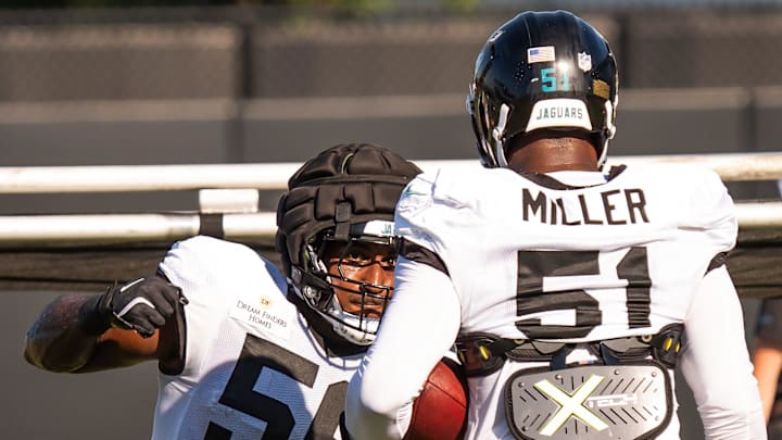Jacksonville Jaguars linebacker Yasir Abdullah (56) prepares to punch the ball loose during an NFL training camp fifth session at the Miller Electric Center, Monday, July 28, 2025, in Jacksonville, Fla. [Doug Engle/Florida Times-Union]