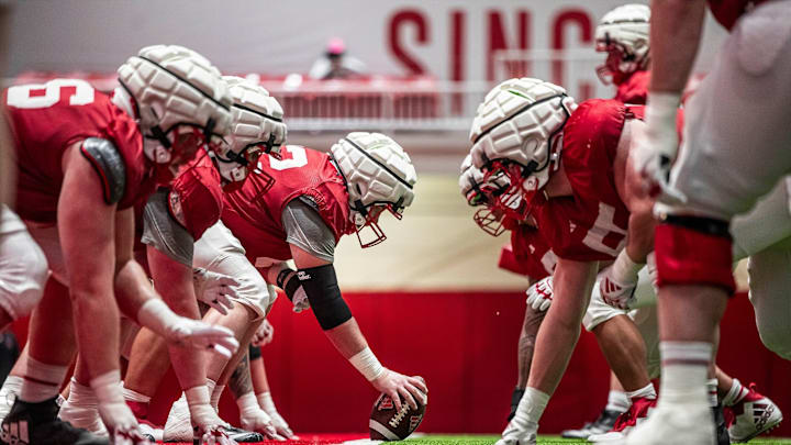 The offensive and defensive lines prepare for a snap during practice. The offensive and defensive lines prepare for a snap during practice.