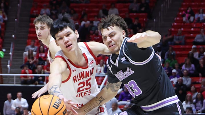 Feb 17, 2025; Salt Lake City, Utah, USA; Utah Utes guard Mike Sharavjamts (25) and Kansas State Wildcats guard Coleman Hawkins (33) play for a loose ball during the first half at Jon M. Huntsman Center. Mandatory Credit: Rob Gray-Imagn Images