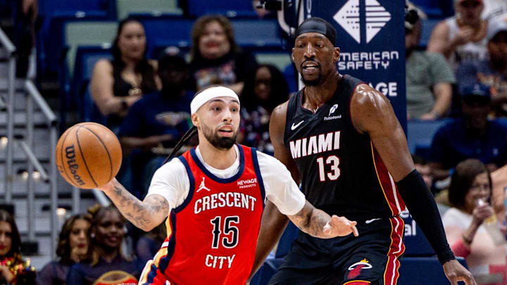 Apr 11, 2025; New Orleans, Louisiana, USA; New Orleans Pelicans guard Jose Alvarado (15) dribbles against Miami Heat center Bam Adebayo (13) during the first half at Smoothie King Center. Mandatory Credit: Stephen Lew-Imagn Images