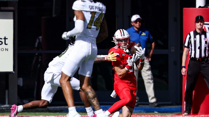 Oct 19, 2024; Tucson, Arizona, USA; Arizona Wildcats defensive back Jack Luttrell (13) intercepts a ball against the Colorado Buffaloes during the second quarter at Arizona Stadium. Mandatory Credit: Aryanna Frank-Imagn Images