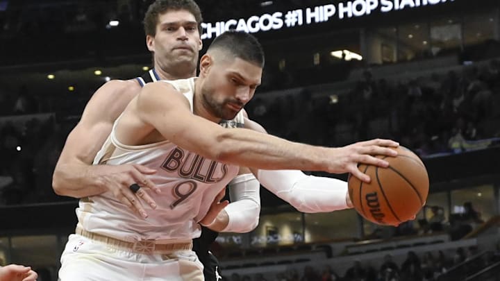 Dec 28, 2024; Chicago, Illinois, USA;  Milwaukee Bucks center Brook Lopez (11) fouls Chicago Bulls center Nikola Vucevic (9) during the second half at the United Center. Mandatory Credit: Matt Marton-Imagn Images
