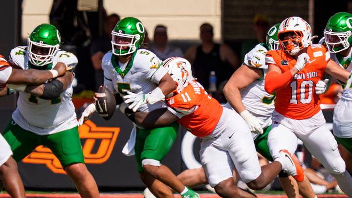 Oregon quarterback Dante Moore's pre-snap stance tipped off the Oklahoma State defense as to what type of play was coming. Oregon quarterback Dante Moore's pre-snap stance tipped off the Oklahoma State defense as to what type of play was coming.