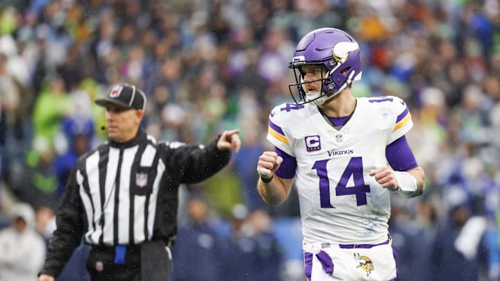 Dec 22, 2024; Seattle, Washington, USA; Minnesota Vikings quarterback Sam Darnold (14) reacts after passing for a touchdown against the Seattle Seahawks during the first quarter at Lumen Field. Joe Nicholson-Imagn Images