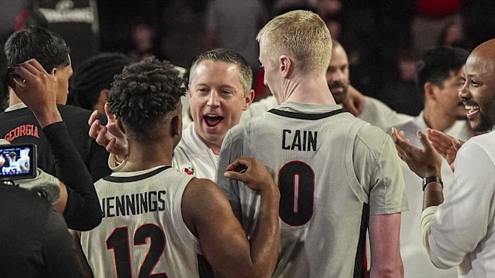 Mar 8, 2025; Athens, Georgia, USA; Georgia Bulldogs head coach Mike White reacts with guard Markel Jennings (12) and guard Blue Cain (0) after Georgia defeated the Vanderbilt Commodores at Stegeman Coliseum. Mandatory Credit: Dale Zanine-Imagn Images