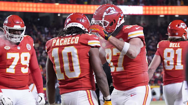 Jan 13, 2024; Kansas City, Missouri, USA; Kansas City Chiefs running back Isiah Pacheco (10) celebrates his touchdown scored against the Miami Dolphins with tight end Travis Kelce (87) during the second half of the 2024 AFC wild card game at GEHA Field at Arrowhead Stadium. Mandatory Credit: Denny Medley-Imagn Images