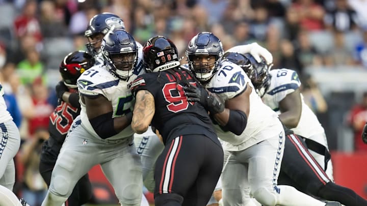 Dec 8, 2024; Glendale, Arizona, USA; Seattle Seahawks center Olu Oluwatimi (51) and guard Laken Tomlinson (70) against Arizona Cardinals defensive tackle Roy Lopez (98) at State Farm Stadium.