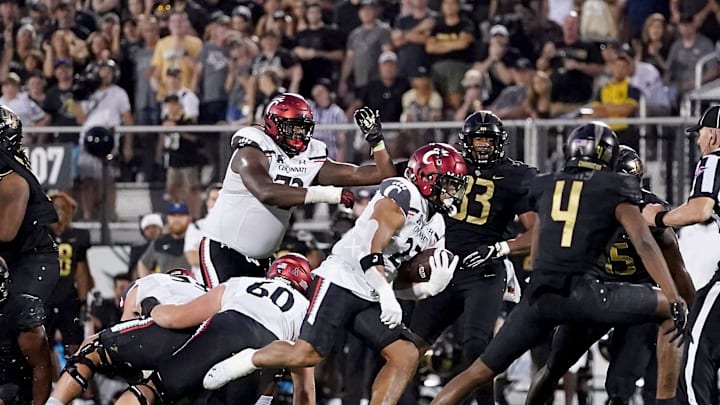Cincinnati Bearcats running back Ryan Montgomery (22) breaks through the line of scrimmage on a touchdown run in the fourth quarter during a college football game against the UCF Knights, Saturday, Oct. 29, 2022, at FBC Mortgage Stadium in Orlando, Fla. The UCF Knights defeated the Cincinnati Bearcats, 25-21.

Ncaaf Cincinnati Bearcats At Ucf Knights Oct 29 1079