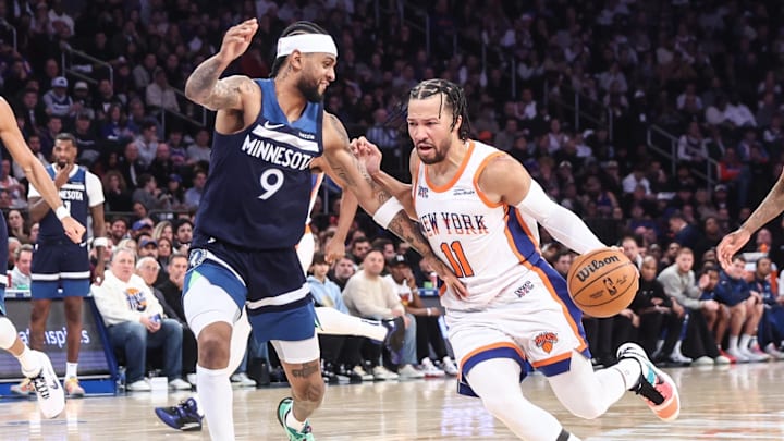 New York Knicks guard Jalen Brunson looks to drive past Minnesota Timberwolves guard Nickeil Alexander-Walker.