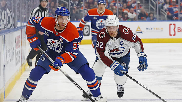 Apr 13, 2026; Edmonton, Alberta, CAN; Edmonton Oilers forward Connor McDavid (97) looks to make a pass in front of Colorado Avalanche forward Gabriel Landeskog (92) during the first period at Rogers Place. Mandatory Credit: Perry Nelson-Imagn Images