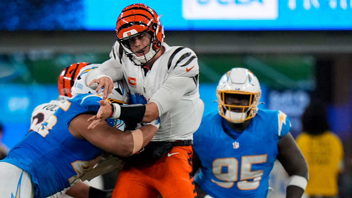 Cincinnati Bengals quarterback Joe Burrow (9) is hit hard by Los Angeles Chargers linebacker Tuli Tuipulotu (45) as he throws in the fourth quarter of the NFL Week 11 game between the Los Angeles Chargers and the Cincinnati Bengals at SoFi Stadium in Inglewood, Calif., on Sunday, Nov. 17, 2024. The Chargers won 34-27.