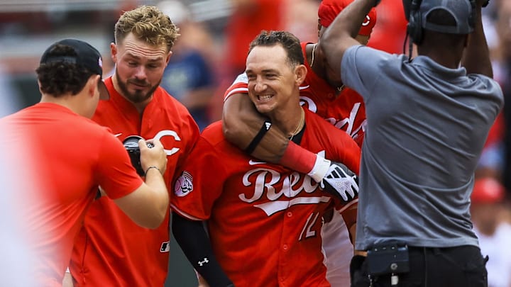 Aug 17, 2025; Cincinnati, Ohio, USA; Cincinnati Reds designated hitter Austin Hays (12) celebrates with teammates after hitting a walk-off single in the tenth inning against the Milwaukee Brewers at Great American Ball Park. Mandatory Credit: Katie Stratman-Imagn Images