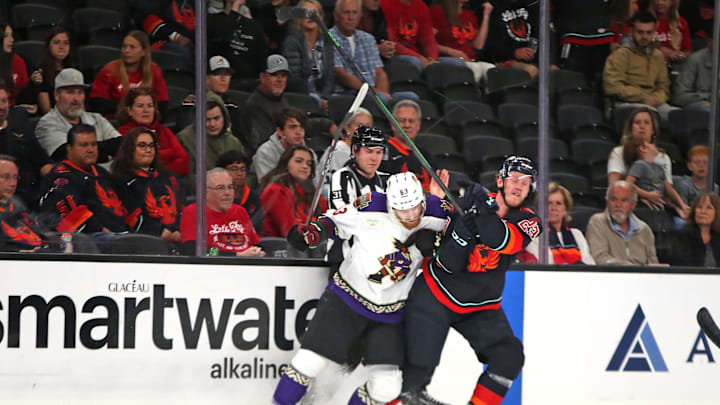 Tucson Roadrunners forward Colin Theisen (63) and Coachella Valley Firebirds defenseman Gustav